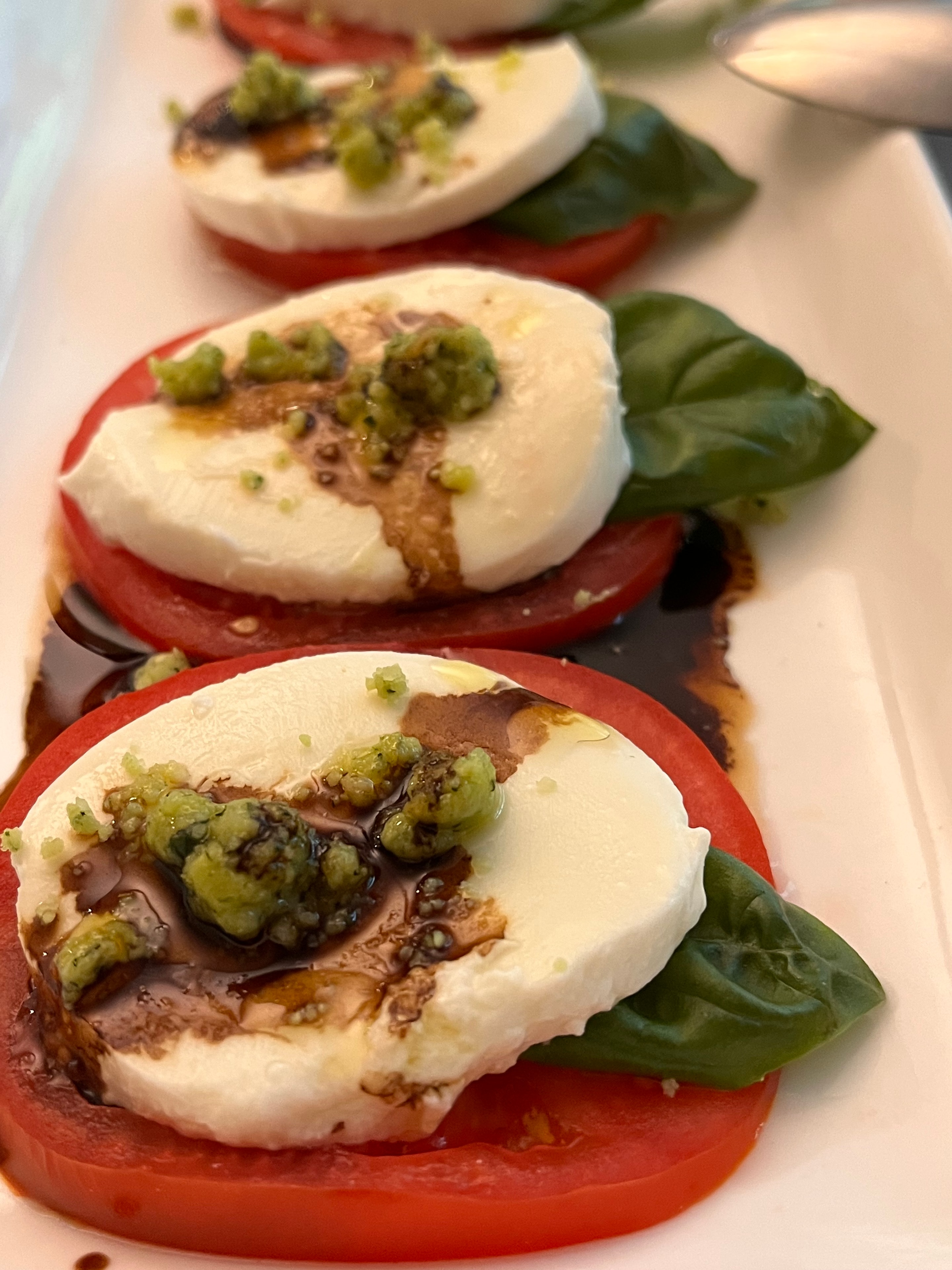 Caprese stacks with pesto and basil
